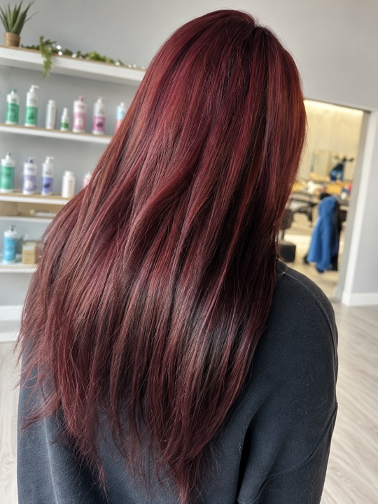 Long burgundy hair viewed from behind — AI-retouched image